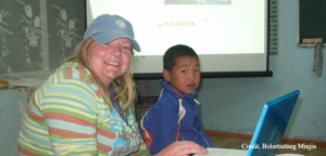 Educational advisor Molly Ward watching a video on Mongolia’s “Fighting Dinosaurs” with a child from the Gobi town of Bulgan.